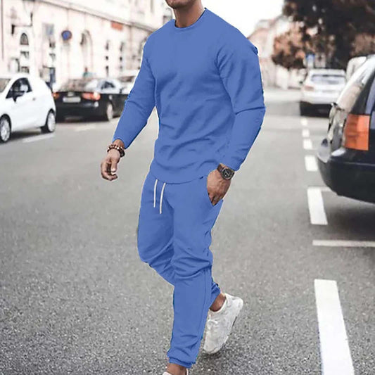 Man wearing blue casual sport pants with matching sweatshirt walking on city street